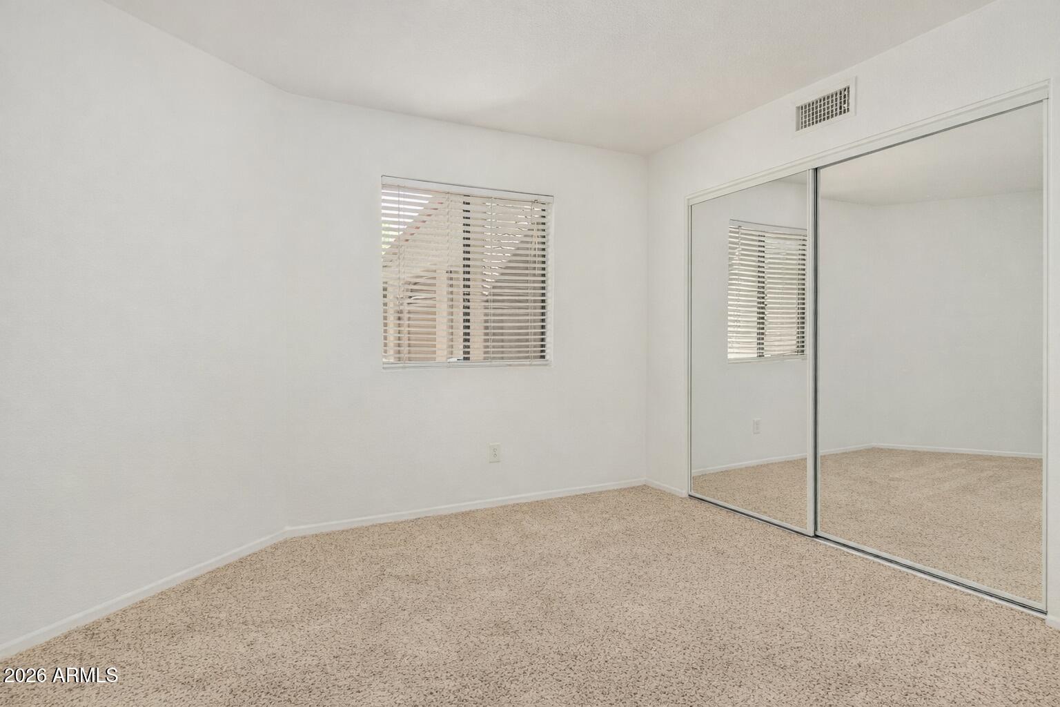 985 North Granite Reef Road, Unit 129 Scottsdale, AZ 85257 - Photo 21 of 38 an empty room with windows