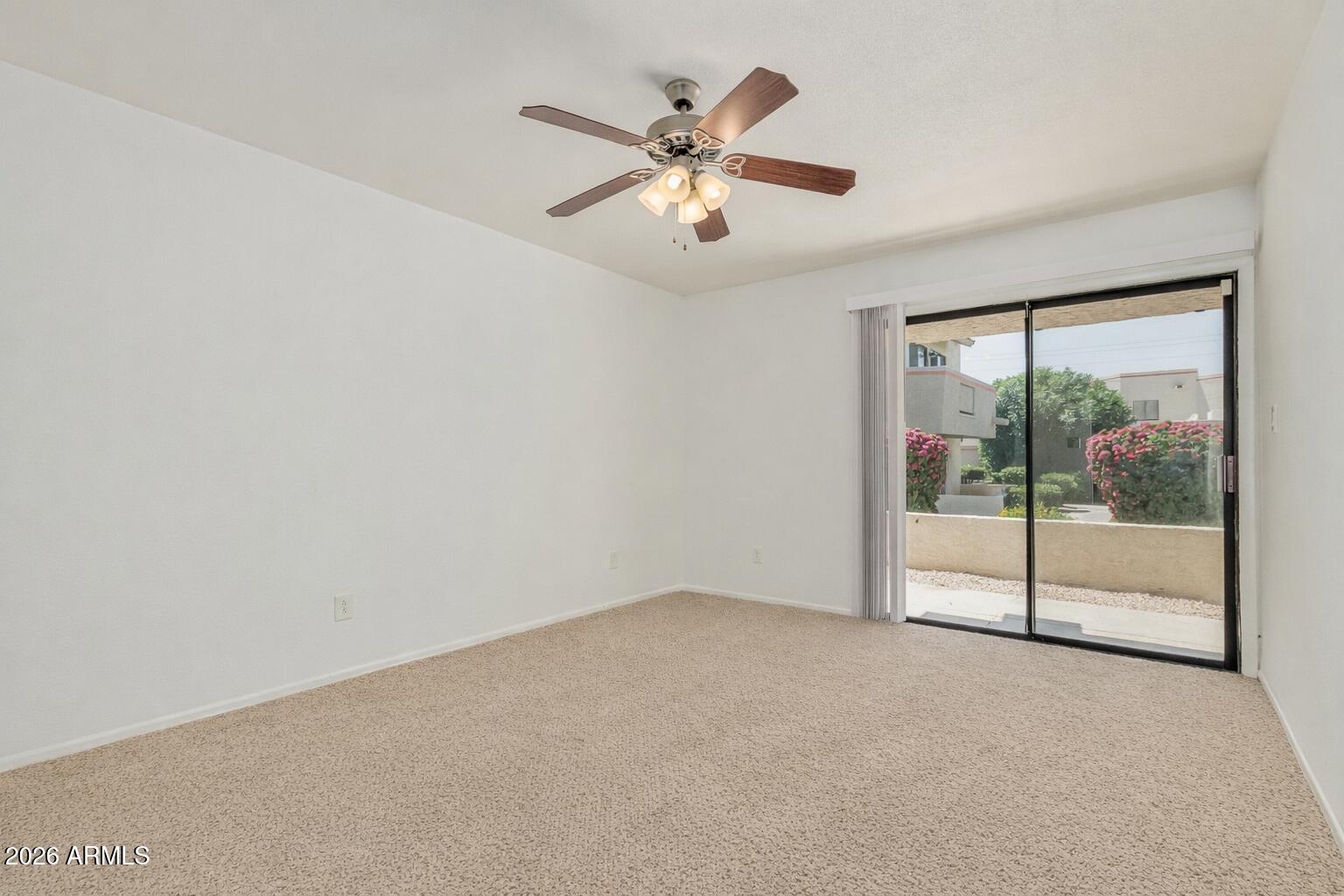 985 North Granite Reef Road, Unit 129 Scottsdale, AZ 85257 - Photo 24 of 38 a view of a livingroom with a ceiling fan and window