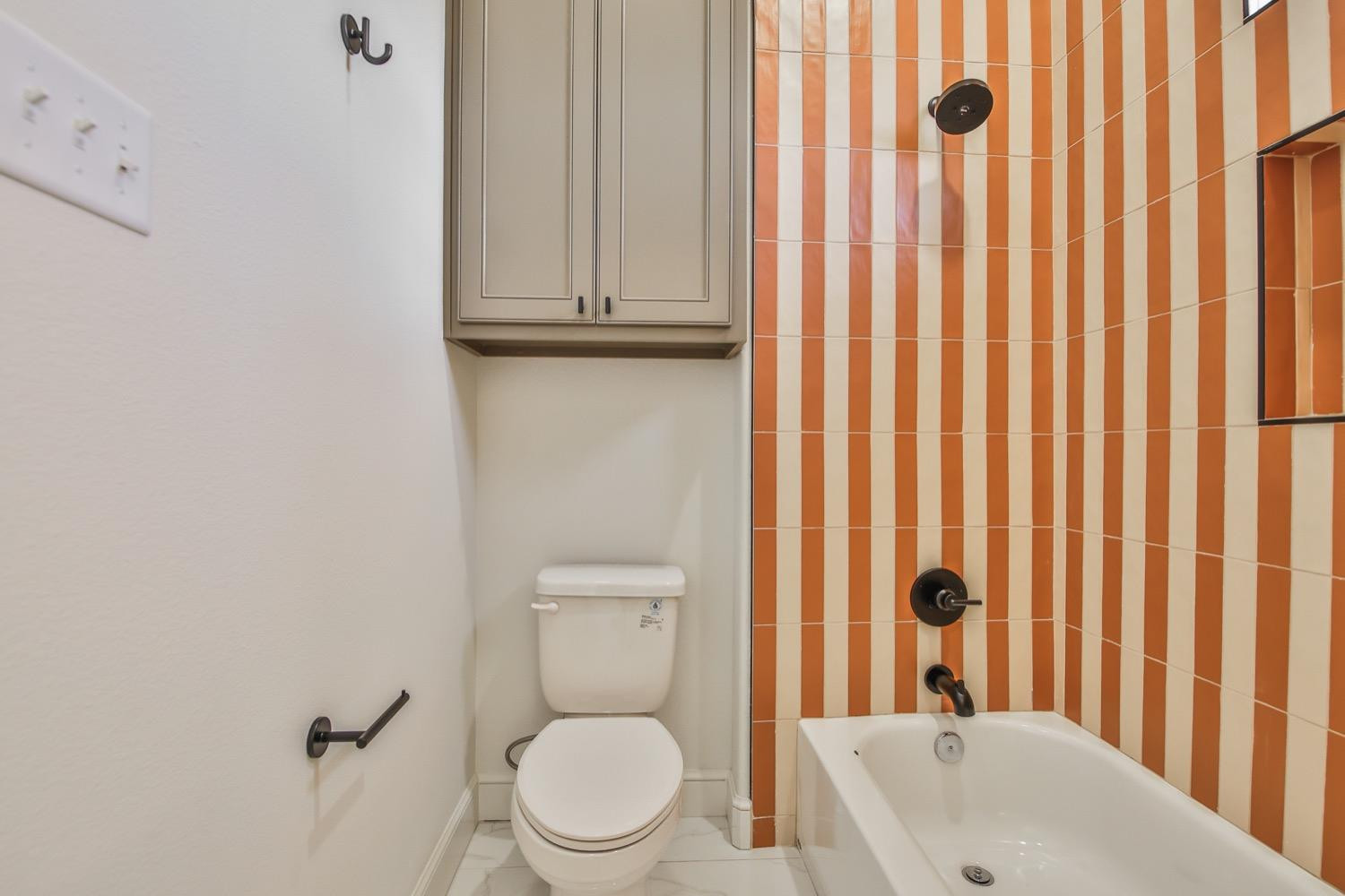 7616 53rd Street Lubbock, TX 79407 - Photo 41 of 50 a bathroom with a toilet a sink and a shower curtain