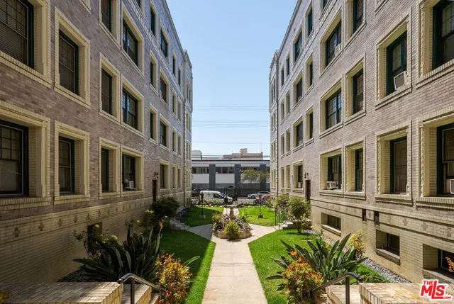 a view of a brick building with many windows