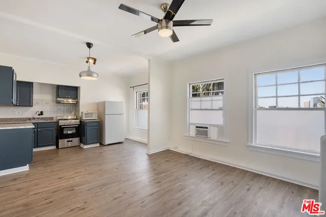a view of a kitchen with a sink hardwood floor and a kitchen