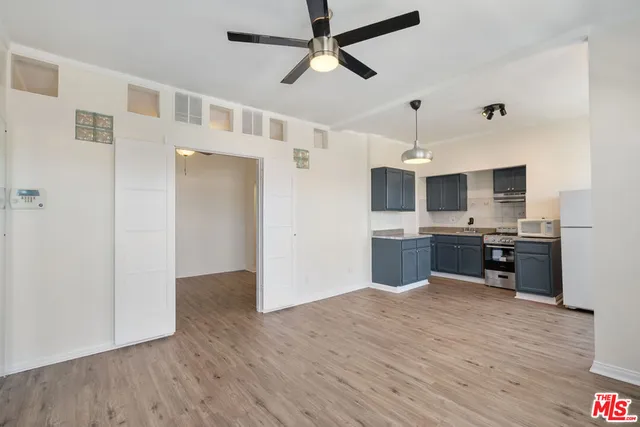 a kitchen with stainless steel appliances kitchen island granite countertop a refrigerator and a sink