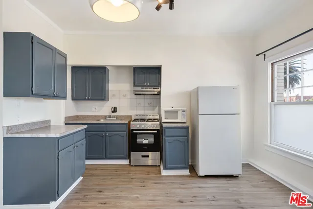 a kitchen with stainless steel appliances granite countertop a refrigerator stove and sink