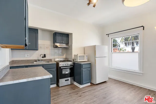 a kitchen with stainless steel appliances a refrigerator stove and sink