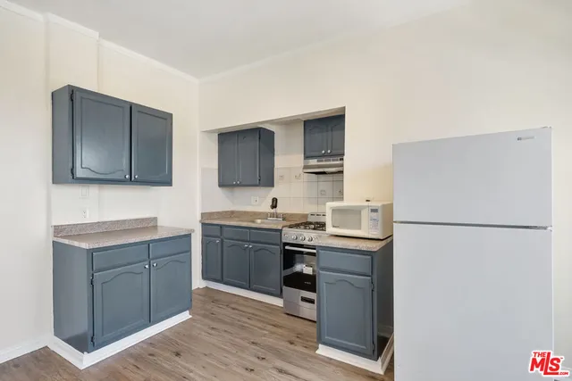 a kitchen with stainless steel appliances a refrigerator stove and sink