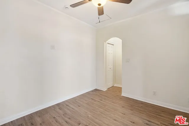 a view of room with wooden floor and ceiling fan
