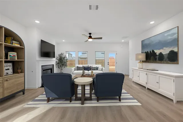 a kitchen with refrigerator cabinets and wooden floor