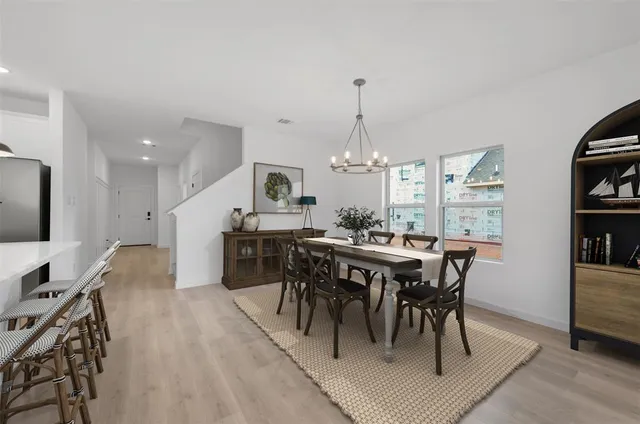 a kitchen with stainless steel appliances kitchen island granite countertop a sink a stove and a refrigerator