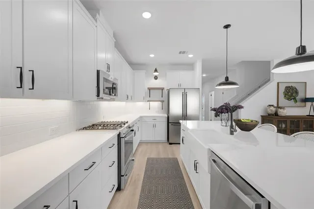 a bedroom with a large bed couch and a window