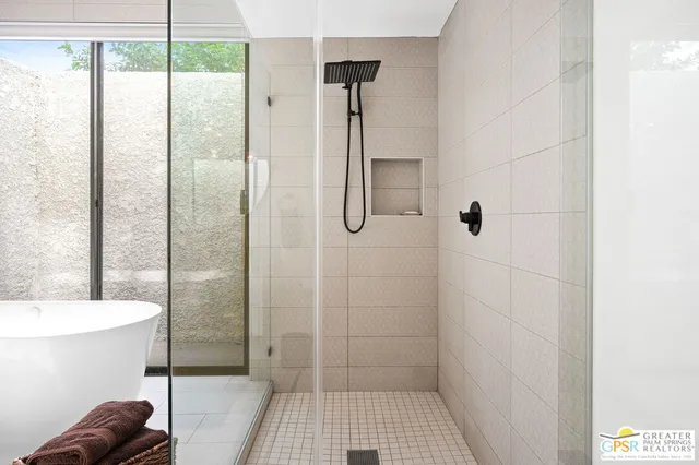 a bathroom with a granite countertop sink a toilet and shower