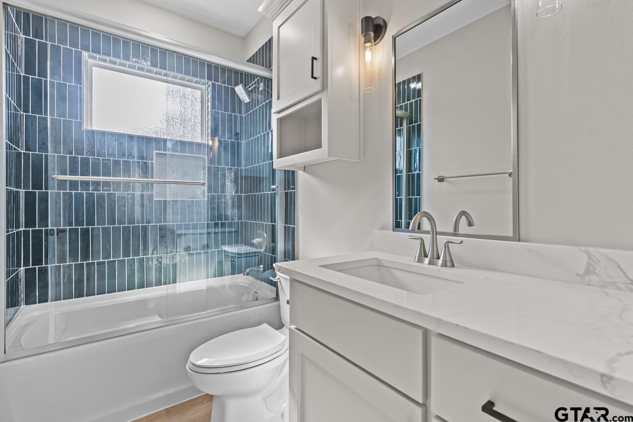 2903 Queens Way West Marshall, TX 75672 - Photo 11 of 17 a bathroom with a sink a toilet and shower
