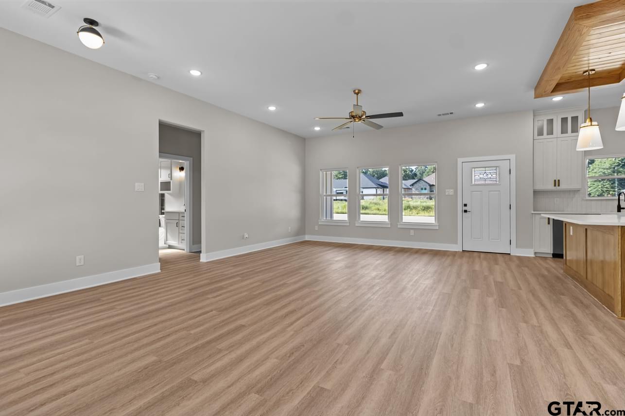 2903 Queens Way West Marshall, TX 75672 - Photo 14 of 17 a view of an empty room with a window and wooden floor
