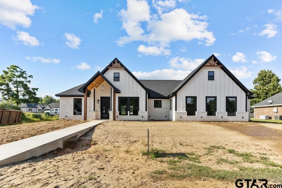 2903 Queens Way West Marshall, TX 75672 - Photo 2 of 17 a front view of a house with a yard covered in snow