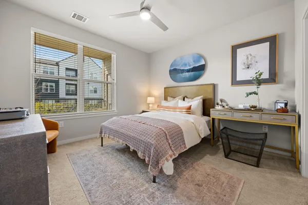 a bedroom with a bed and a window