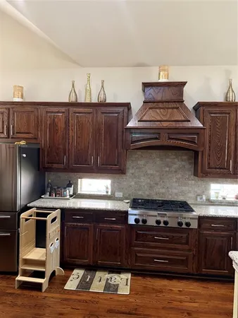 a kitchen with stainless steel appliances granite countertop a stove and a cabinets