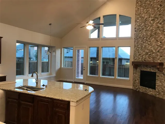 a kitchen with a sink and wooden floor