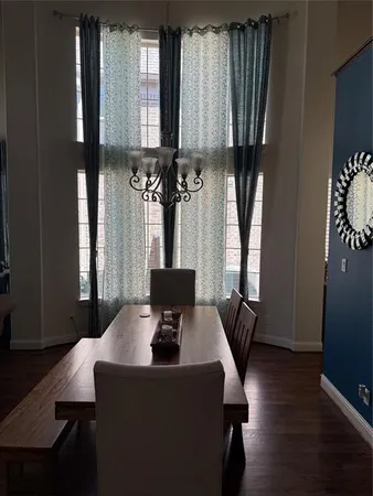 a view of a dining room with furniture and window