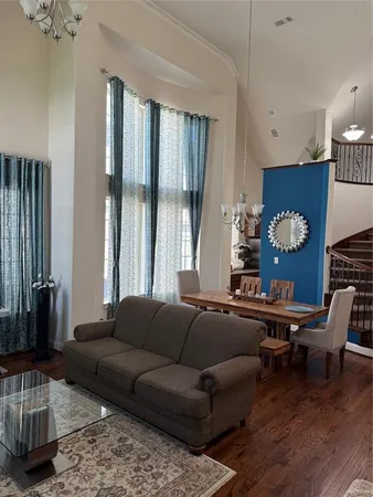 a living room with furniture and wooden floor