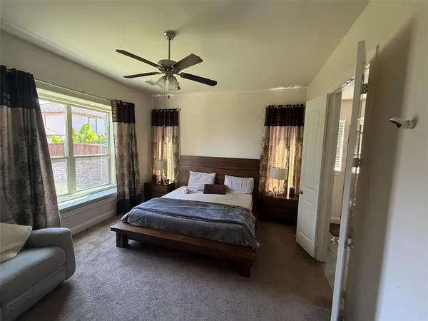 a bedroom with a bed couch and a window