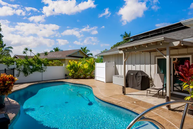 a view of a backyard with plants and a patio