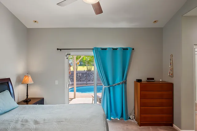 a bedroom with a bed and a mirror