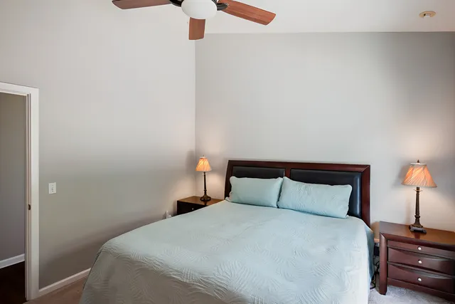 a bedroom with a bed and a lamp