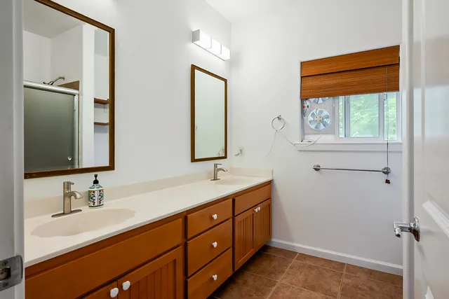 a bathroom with a double vanity sink and mirror
