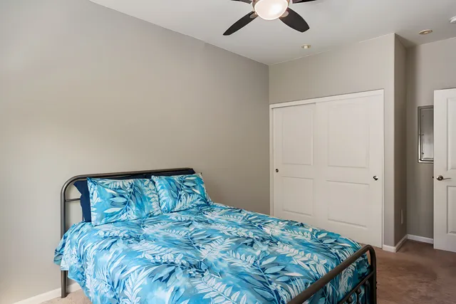 a bedroom with a bed and a chandelier