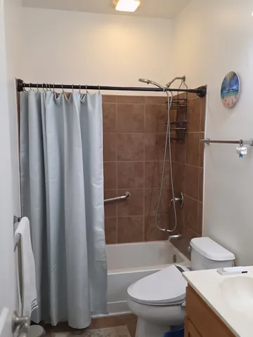 a bathroom with a toilet and a shower