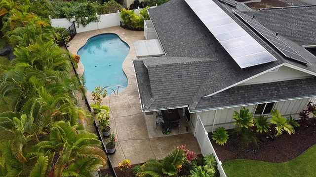 an aerial view of a house with a yard and potted plants