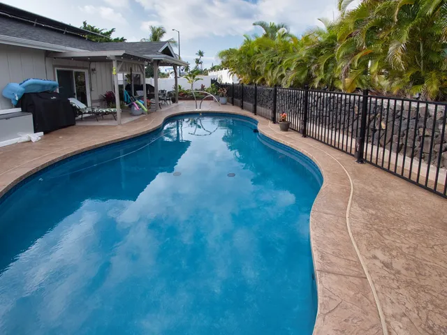 a swimming pool view with a outdoor seating