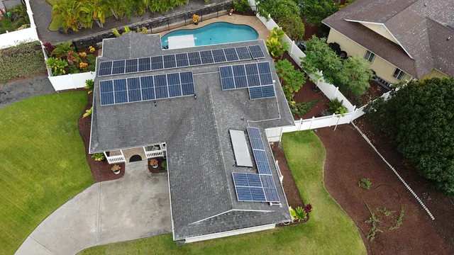 an aerial view of a house with a yard