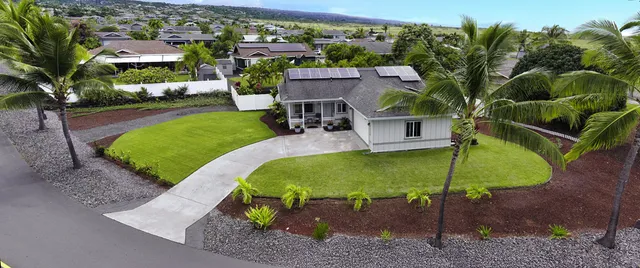 an aerial view of a house with swimming pool garden and patio
