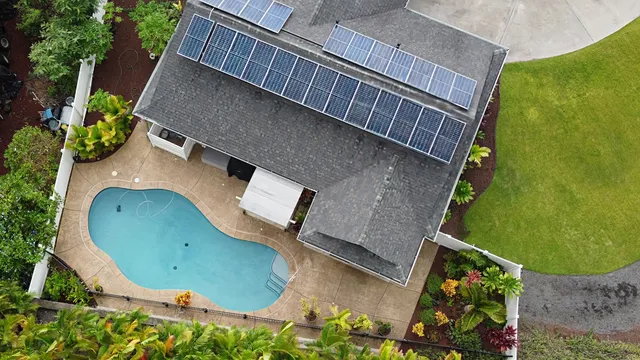 an aerial view of a house with a swimming pool