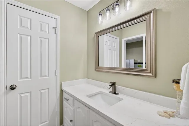 a bathroom with a sink vanity and a mirror