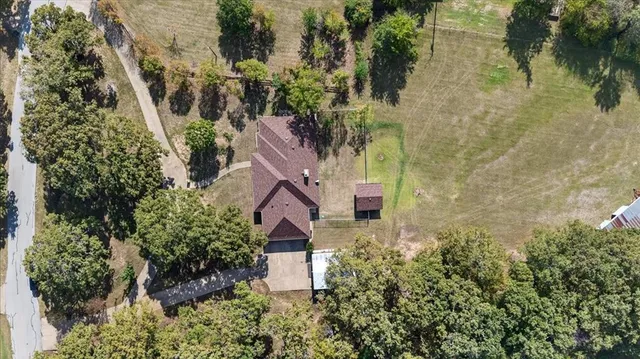 an aerial view of a house with a yard