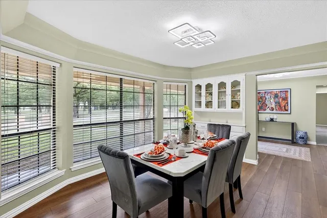 a dining room with furniture a rug and wooden floor