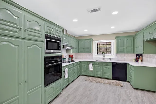a kitchen with lots of counter space and appliances