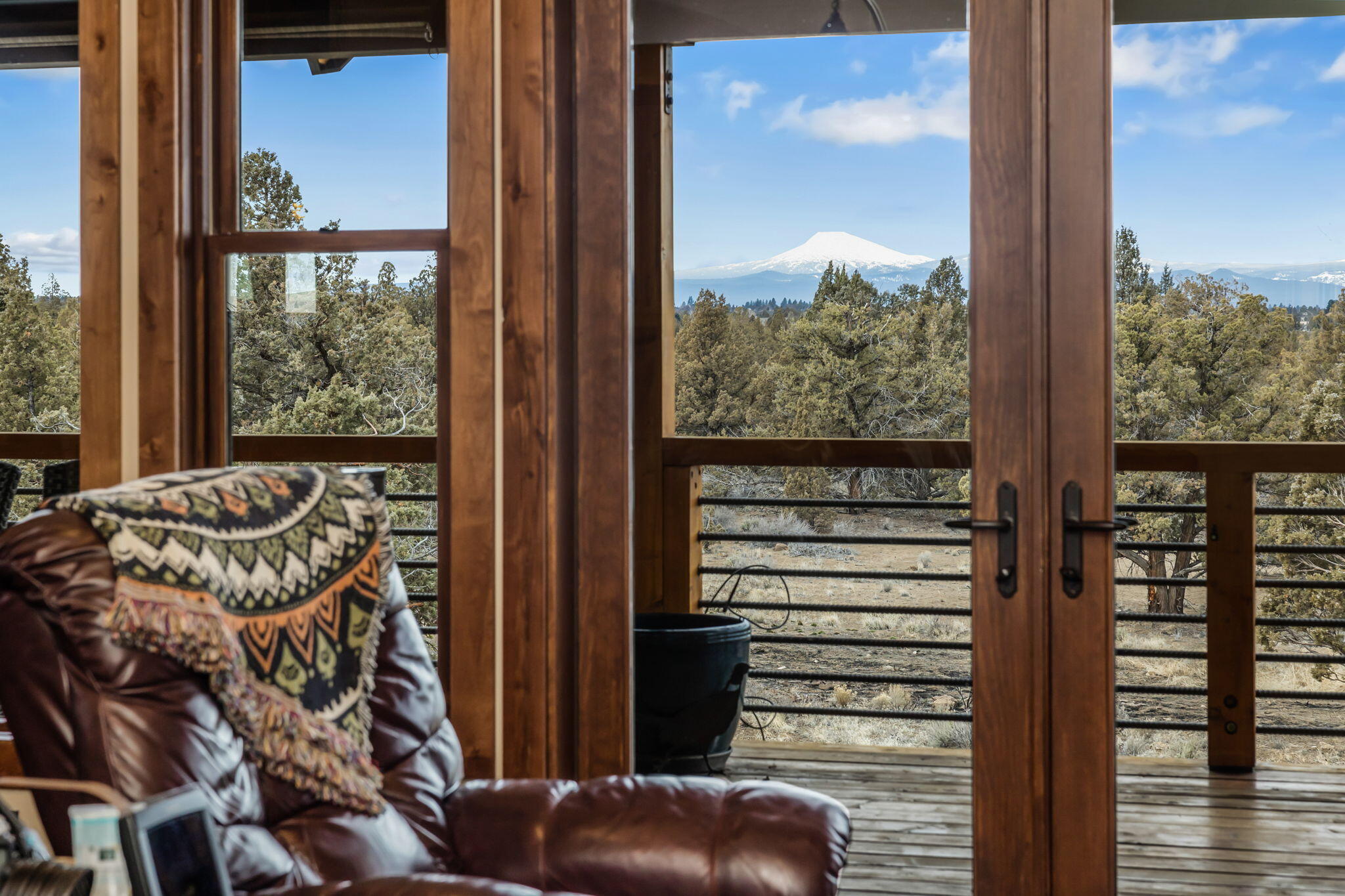 23150 Rickard Road Bend, OR 97702 - Photo 15 of 60 a view of a balcony with furniture and floor to ceiling window