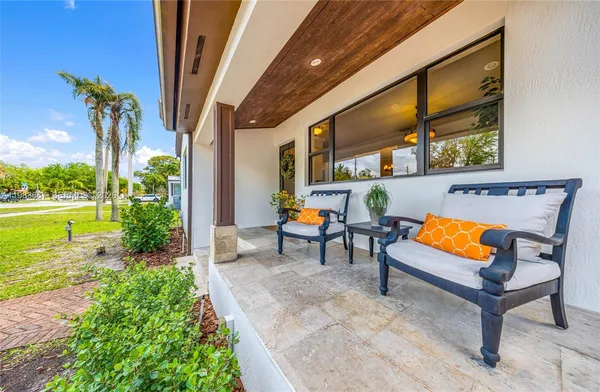a backyard of a house with outdoor seating
