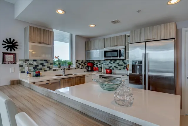 a kitchen with a refrigerator and a sink
