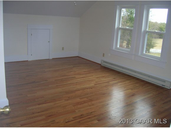 531 Steeles Fort Road Raphine, VA 24472 - Photo 11 of 16 an empty room with wooden floor and windows