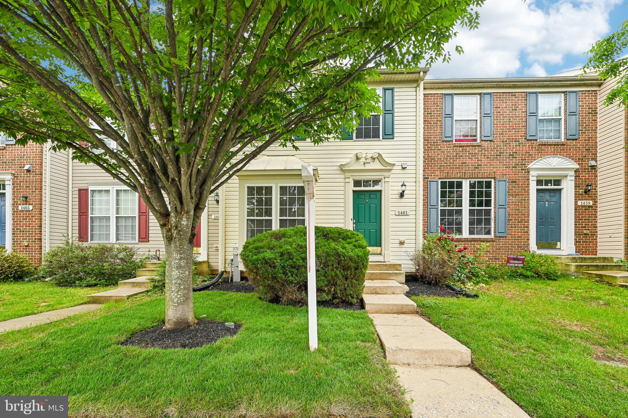 1461 Pangbourne Way Hanover, MD 21076 - Photo 2 of 51 a view of a brick house with a big yard and large trees
