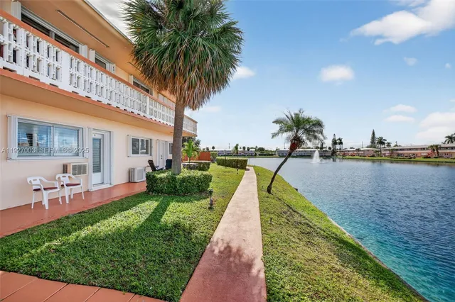 a swimming pool with outdoor seating and yard