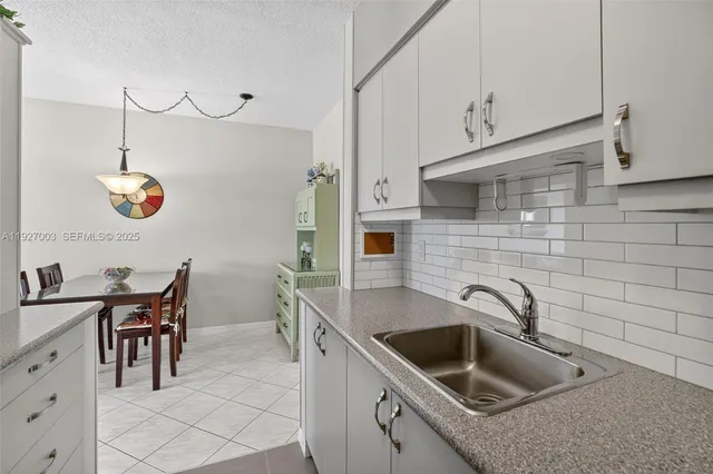 a kitchen that has a sink and a stove