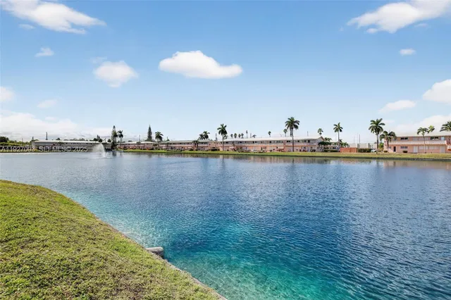 a view of a water with boats and trees in the background