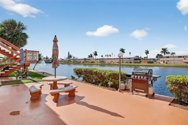 a view of a lake with a table and chairs