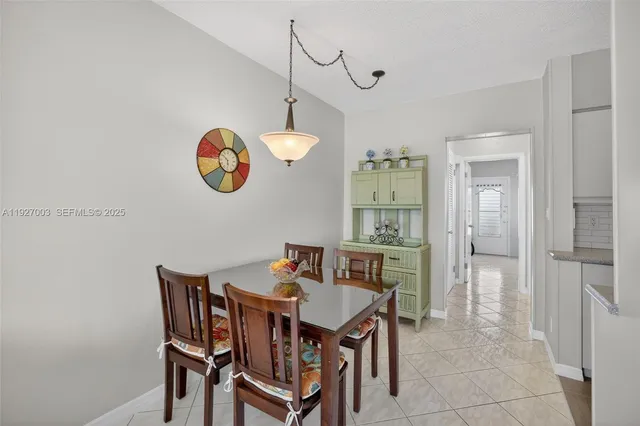 a dining room with a wooden table and chairs