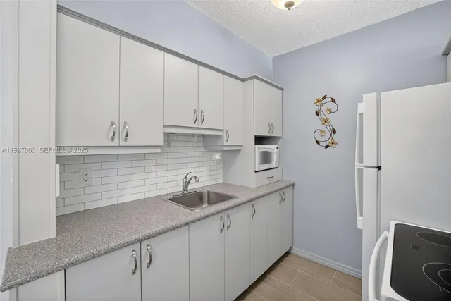 a kitchen with a sink and cabinets