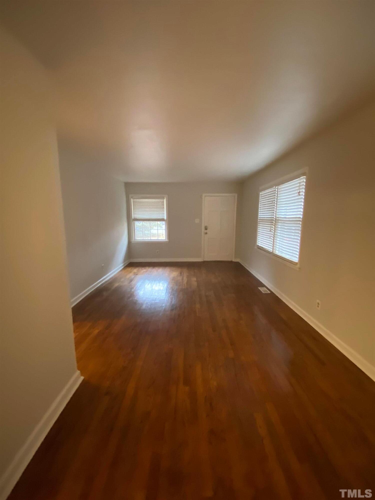 2418 Stevens Road Raleigh, NC 27610 - Photo 14 of 17 an empty room with wooden floor and windows